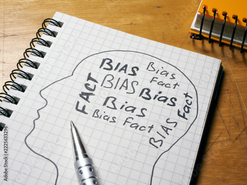 Head outline filled with bias and fact words.