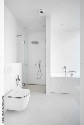 Modern empty clean white bathroom interior mockup with bathtub, glass shower cabin, and toilet.