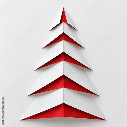 Folded white paper Christmas tree revealing red beneath its stepped edges