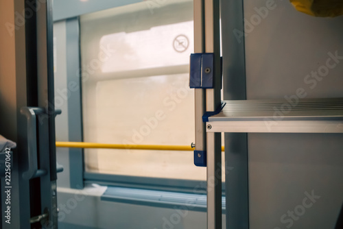 Fotografie Sleeper train compartment interior with window beige blind and yellow handrail a
