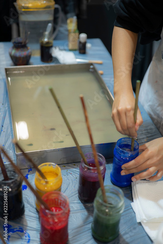 Artist Holding Blue Paintbrush During Traditional Turkish Ebru Water Marbling Workshop