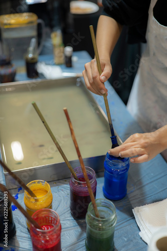 Artist Mixing Blue Pigment During Traditional Turkish Ebru Water Marbling Workshop