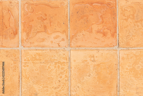 Textured clay tiles in shades of orange on the terrace of a Mediterranean villa