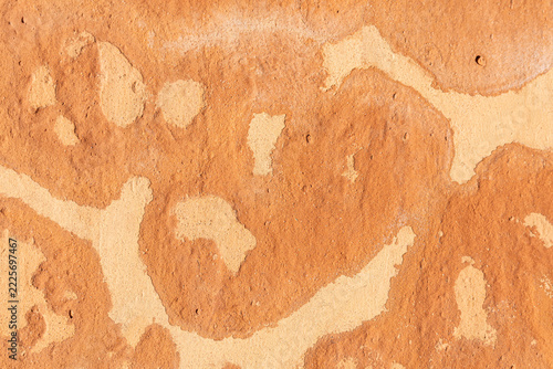 Natural, handcrafted tile with abstract patterns in shades of orange and beige and a rough texture
