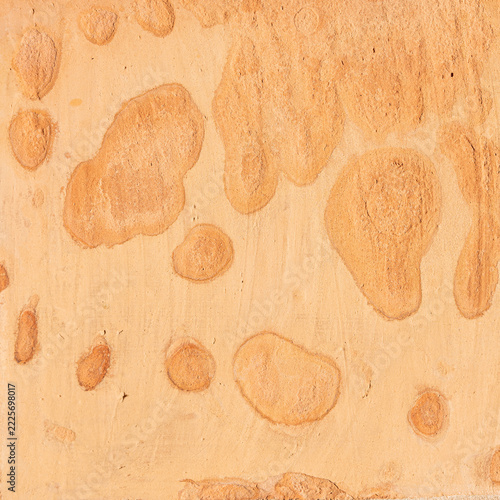 Adobe mud plaster creating an abstract textured background with unevenbackground patterns