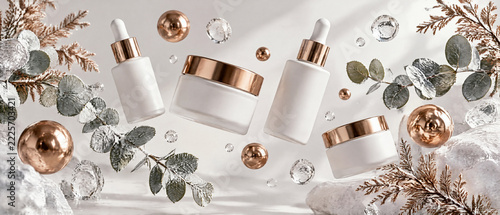 Panoramic 3D banner of floating botanical cosmetics with copper spheres and frosted eucalyptus