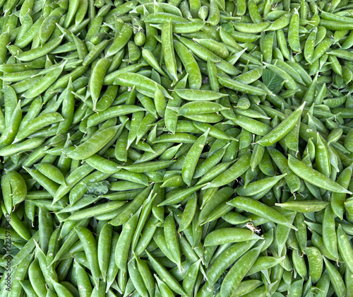 Pile of fresh snap peas at a market stand