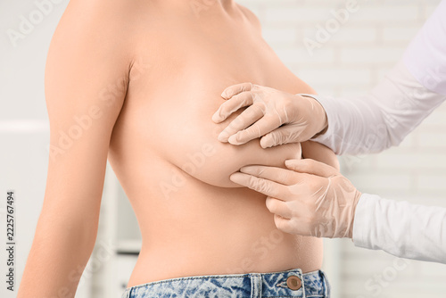Breast cancer screening and self examination, doctor performing clinical brea...