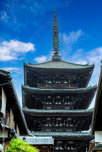 Historic 5-story Yasaka Pagoda as seen on Sannenzaka, an ancient stone-paved path dating back to 808 AD in the Heian period. The 46m tall pagoda is a beautiful example of Hakuho Period architecture.