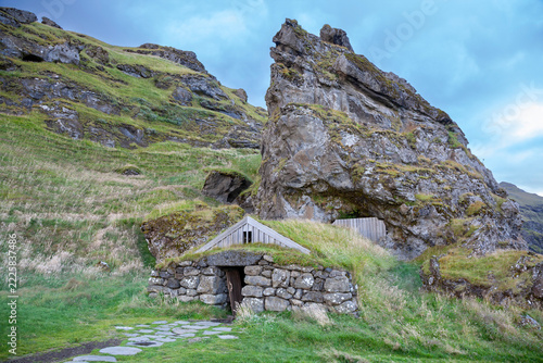 a manmade shelter built into the side of a mountain in south iceland