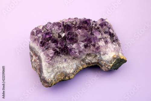 Purple Amethyst Crystal Cluster on a Light Lavender Background