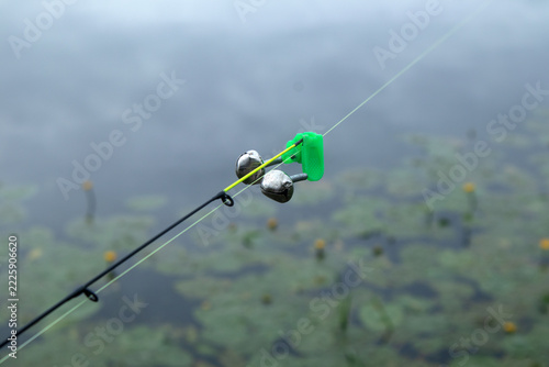 Fishing Rod Tip with Bite Alarm Bells over a Pond