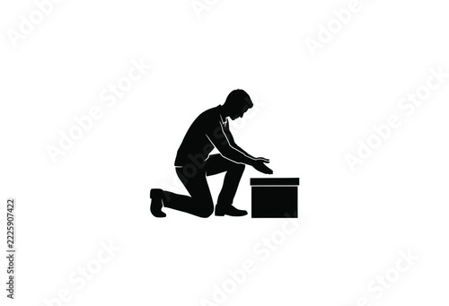 Kneeling man silhouette reaching towards a small box on a white background