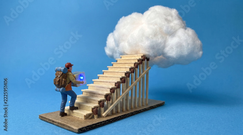 Miniature backpacker carrying glowing data chip up wooden staircase toward fluffy cotton cloud on blue background, cloud computing and data upload concept
