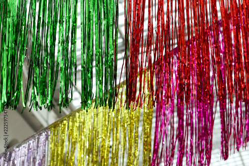 Obraz na plátně Vibrant metallic tinsel hangs in rainbow colors