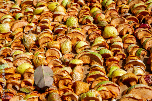 Traditional homemade fruit preservation, seasonal harvest, natural food drying, and preparation of dried apples for long-term storage and healthy snacks.