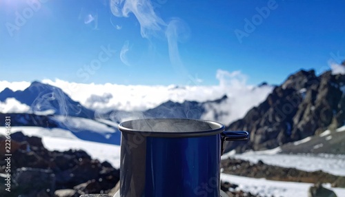 Metal cup on snowy mountain peak.