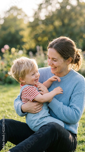Happy Mother Embracing Joyful Child in Sunny Garden