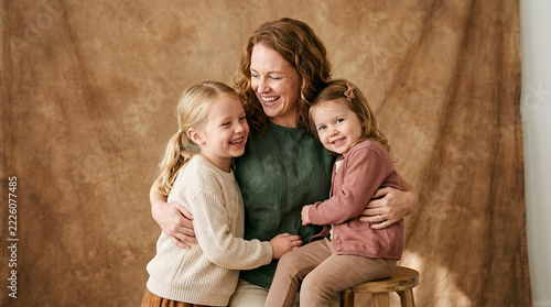 Happy Mother Hugging Two Young Daughters Studio Portrait Joyful Family Moment Natural Expressions