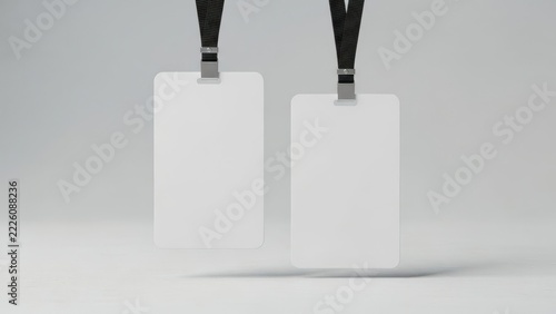 Two blank id cards with black lanyards hanging