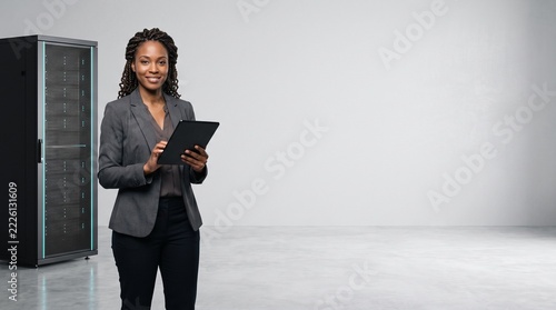 Confident IT Engineer Using Tablet in Data Center Server Room