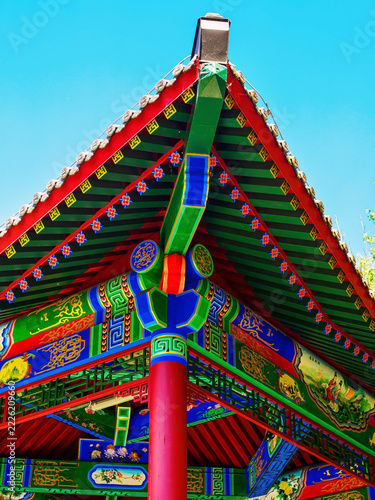 a brightly painted cornice and a system of wooden brackets (dougong) on ​​a Chinese-style pavilion