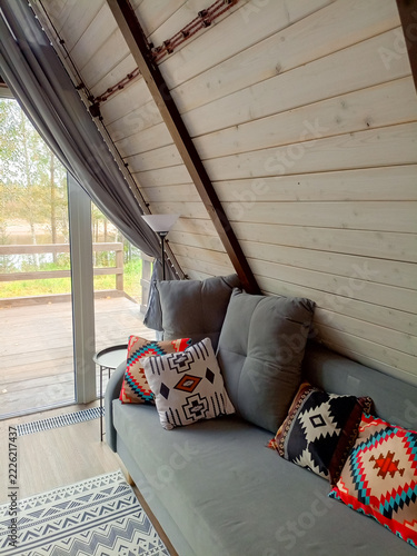 interior of a wooden house, living room with sofa and pillows