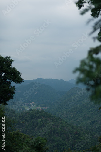 Scenic Mountain View of Yai with Lush Greenery and Overcast Sky