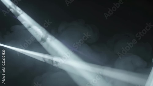 Volumetric Light Beams Moving Through Dark Colored Fog