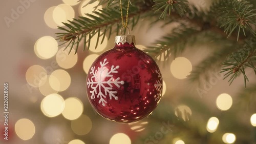 Red Christmas Ornament with Golden Lights and Evergreen Branch