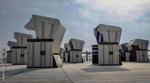 A photo of a place of complete relaxation: the raised plateau on the beach at Sankt Peter-Ording, where traditional beach chairs are set up.