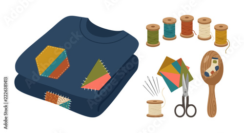 Folded dark blue sweater with colorful patches and sewing supplies