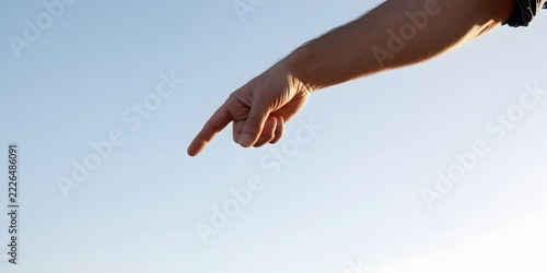 Person pointing with an index finger in an expressive gesture directing attention and indicating a direction for communication and promotional concepts with a bold visual emphasis on the hand movement