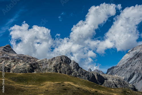 Canvas Print white clouds in a blue sky over the rocky mountains of the French Parc National