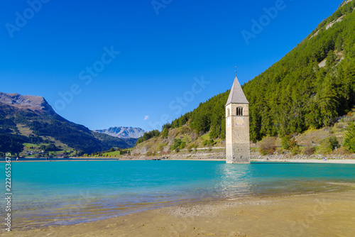 Famous sunken 14th-century church bell tower emerging from Lake Reschen (Reschensee), South Tyrol, Italy