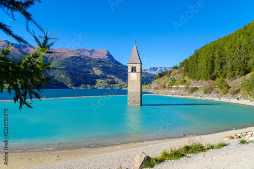 Famous sunken 14th-century church bell tower emerging from Lake Reschen (Reschensee), South Tyrol, Italy
