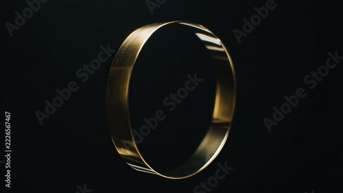 Commitment and eternity concept golden wedding ring as a symbol of marriage and love isolated on a dark background elegant jewelry band with metallic reflection