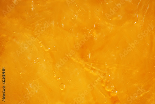 Macro texture of crystalline ice form on top layer of iced tea drink 