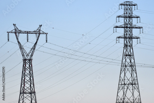 electricity pylons under a blue sky
