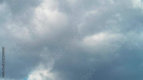 Time-lapse of fluffy white cumulus clouds moving across blue sky
