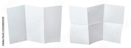 Fotografie Two unfolded white paper sheets with different folding patterns, isolated on tra