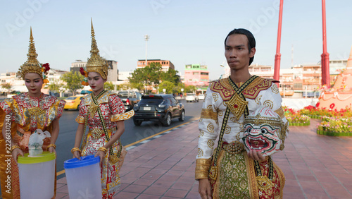 Fotografie Thai Khon Performers in Traditional Costumes Standing by City Street