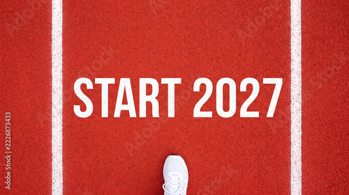 Top down view of a running shoe at the starting line with start 2027 text