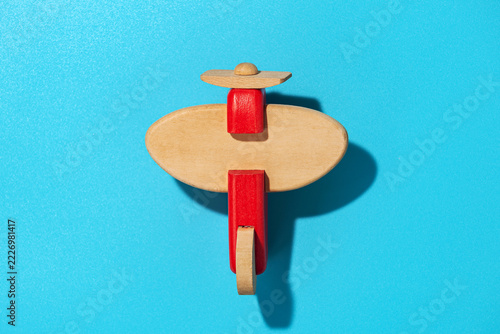 Wood airplane on blue background, top view
