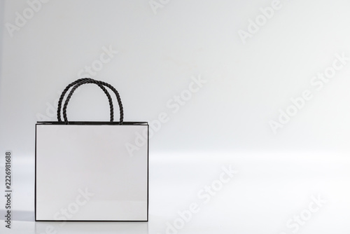 Empty white shopping bag on blue background, top view