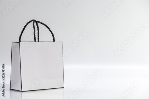 Empty white shopping bag on blue background, top view