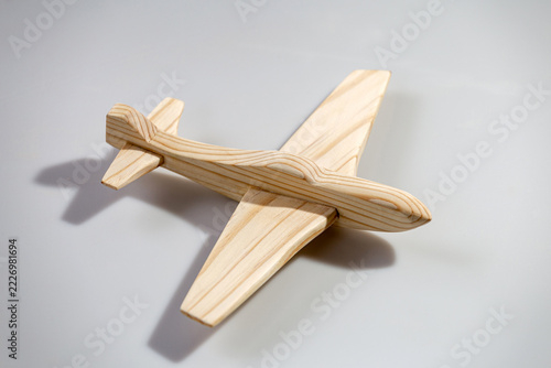 Wood airplane on white background, top view