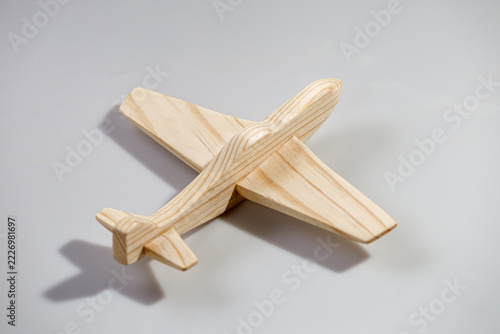 Wood airplane on white background, top view