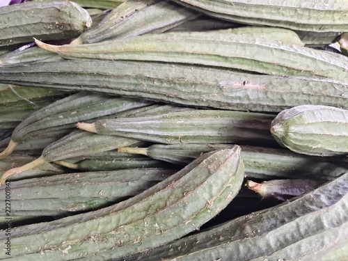 Fotografie Chinese okra (oyong or ridge gourd) is a long, green vegetable with distinct ridges