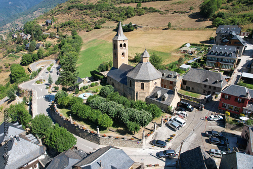 Aerial view of  Romanesque Church of Sant Feliu nestled in a picturesque mountain village Vilac in the Aran Valley. Lleida, Catalan Pyrenees, Spain.